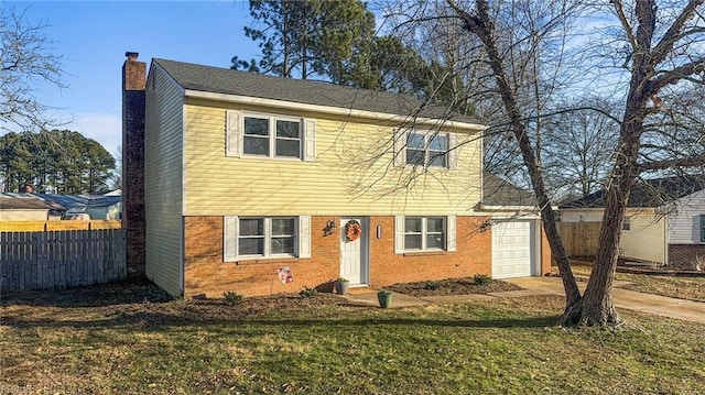 view of front of home with a garage and a front lawn