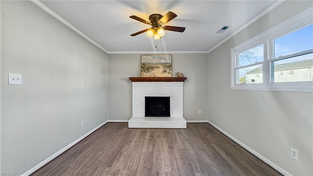 unfurnished living room featuring ceiling fan, crown molding, dark hardwood / wood-style floors, and a brick fireplace