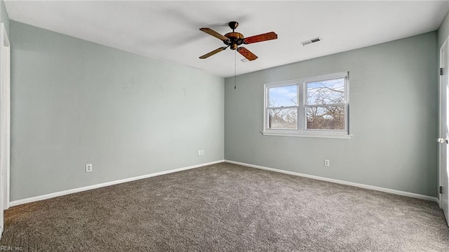 carpeted spare room with ceiling fan