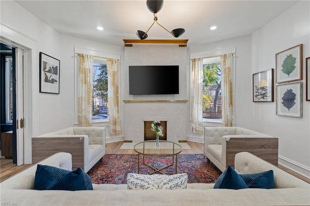 living room featuring a notable chandelier and light hardwood / wood-style floors