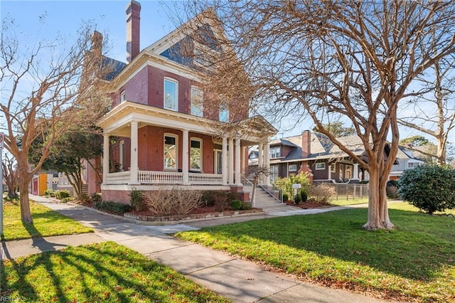 view of front of house featuring covered porch and a front yard