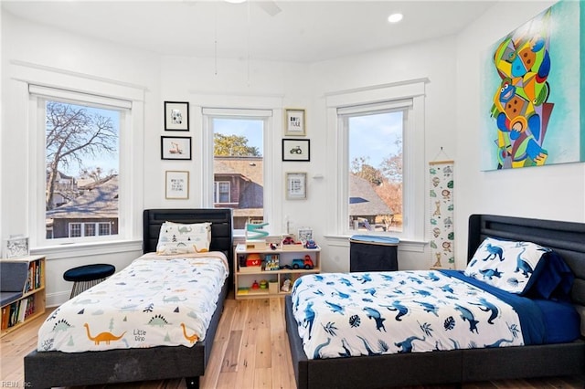 bedroom with light hardwood / wood-style floors and ceiling fan