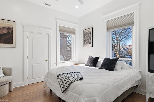 bedroom with light hardwood / wood-style floors and ceiling fan