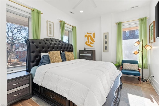 bedroom with light wood-type flooring and multiple windows