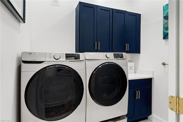 laundry area with cabinets and independent washer and dryer