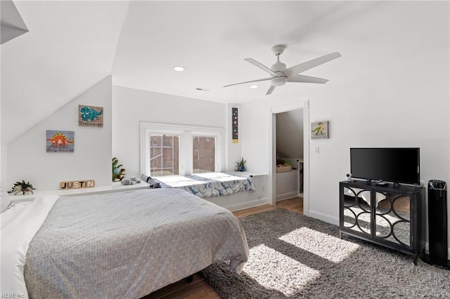 bedroom featuring ceiling fan, dark hardwood / wood-style flooring, and vaulted ceiling