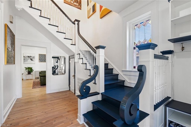 stairway with hardwood / wood-style flooring