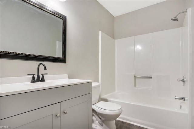 full bathroom with vanity, hardwood / wood-style flooring, toilet, and shower / washtub combination