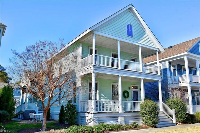 view of front of property featuring covered porch and a balcony