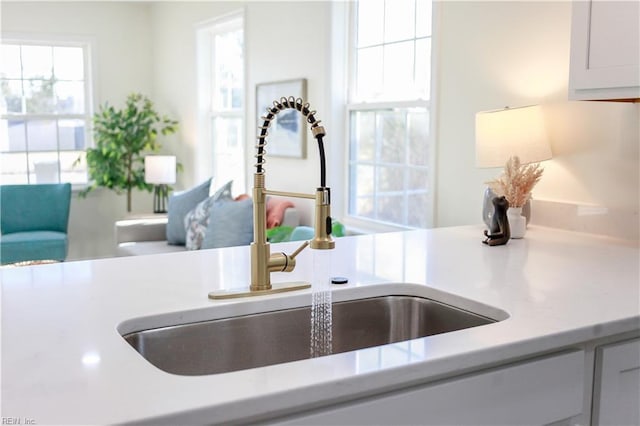 interior details with white cabinets and sink