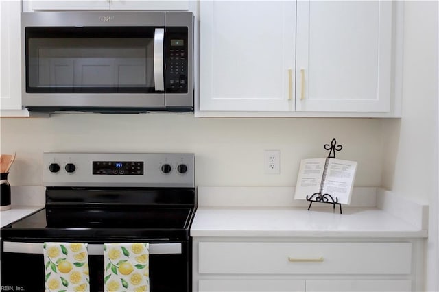 kitchen with stainless steel appliances and white cabinetry