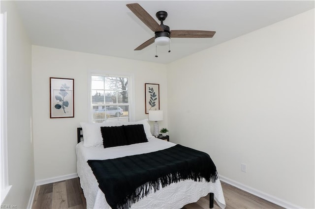 bedroom featuring hardwood / wood-style floors and ceiling fan