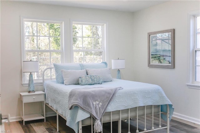 bedroom with dark hardwood / wood-style floors