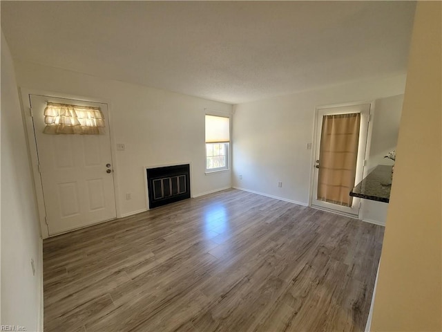 unfurnished living room featuring hardwood / wood-style floors