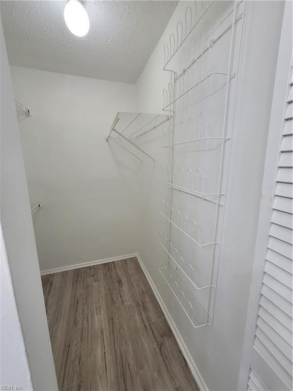 walk in closet featuring hardwood / wood-style flooring