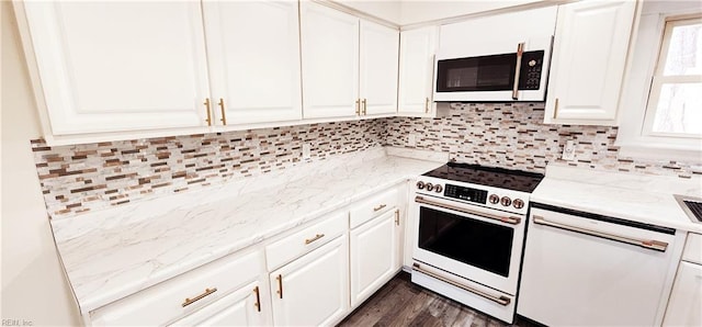 kitchen featuring white appliances, dark hardwood / wood-style floors, white cabinetry, and light stone counters