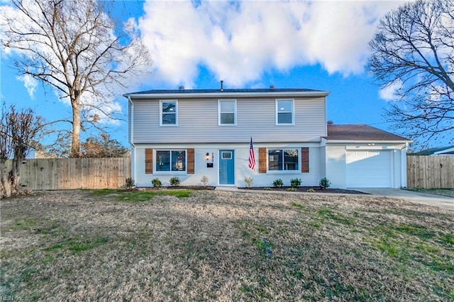 view of front of property with a front yard and a garage