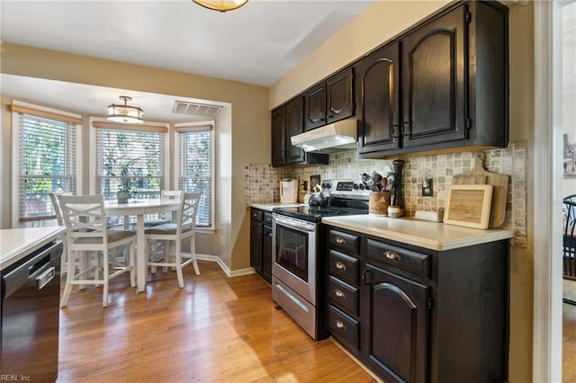 kitchen featuring tasteful backsplash, black dishwasher, electric range, and light wood-type flooring