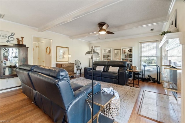 living room featuring crown molding, ceiling fan, beam ceiling, and hardwood / wood-style floors