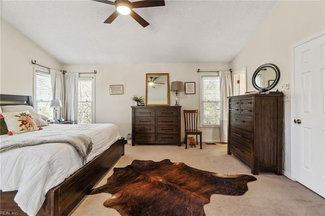 bedroom with light colored carpet, vaulted ceiling, and multiple windows