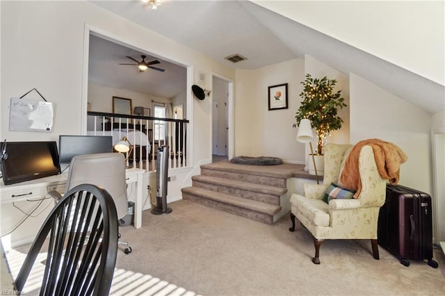 interior space with vaulted ceiling, light carpet, and ceiling fan