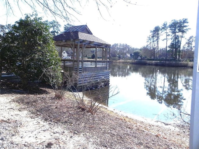 view of dock featuring a gazebo and a water view