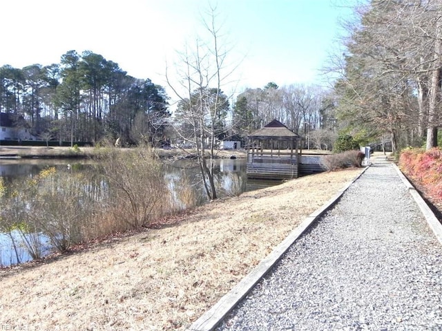 view of dock with a gazebo and a water view