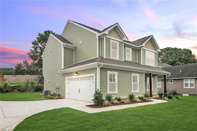 view of front facade with a garage and a yard