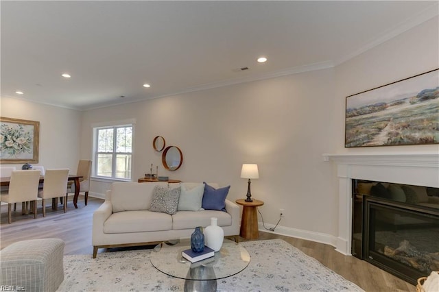 living room with light hardwood / wood-style floors and ornamental molding