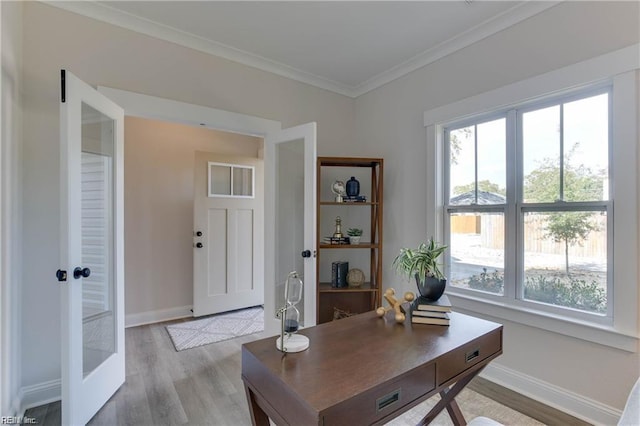 home office with ornamental molding, light hardwood / wood-style flooring, and french doors