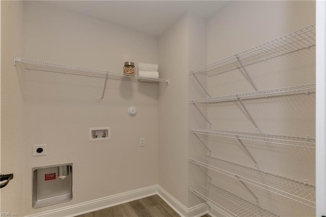 laundry room with hookup for an electric dryer, wood-type flooring, hookup for a washing machine, and gas dryer hookup