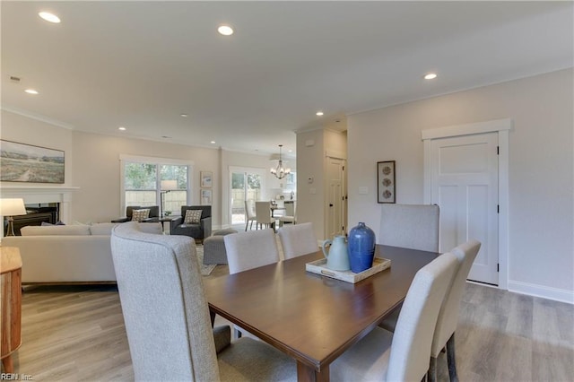 dining space featuring an inviting chandelier and light hardwood / wood-style flooring