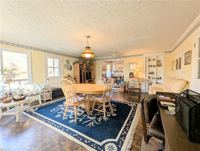 dining area with crown molding, built in features, and a textured ceiling