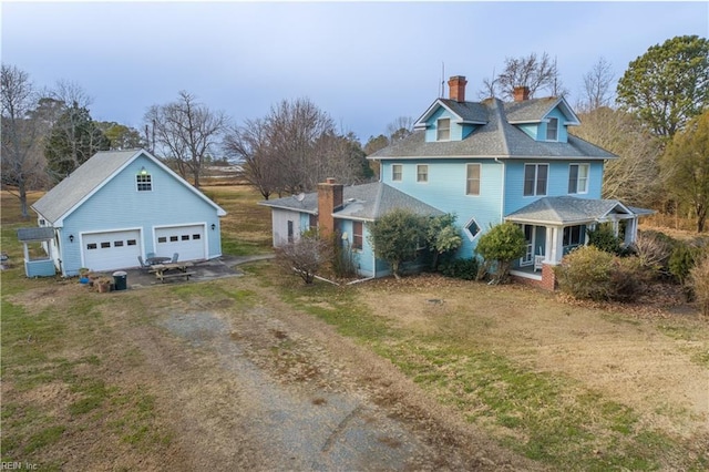 view of home's exterior featuring a garage, covered porch, and a lawn