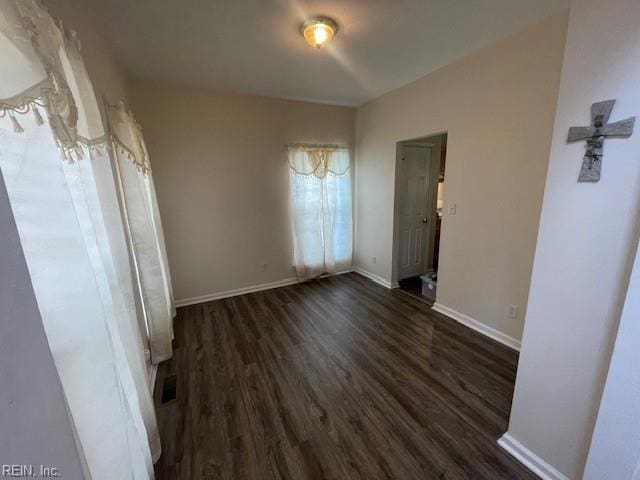 unfurnished bedroom with dark wood-type flooring