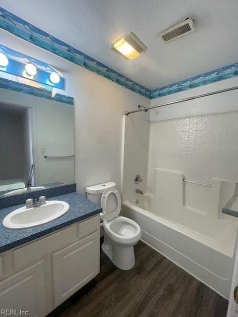 full bathroom featuring vanity, toilet, wood-type flooring, and shower / washtub combination