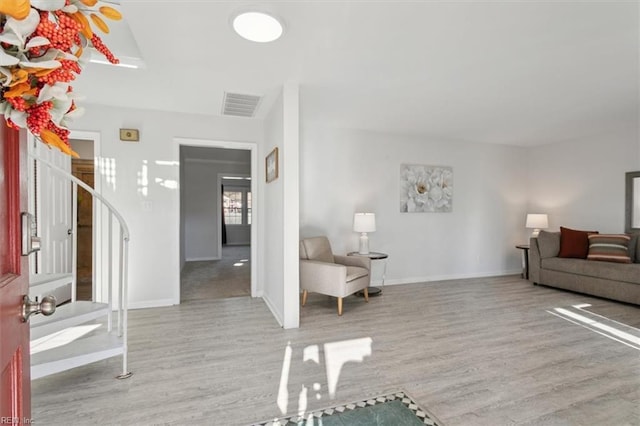 entrance foyer with ceiling fan and light wood-type flooring