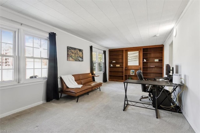 home office with built in shelves, carpet flooring, ornamental molding, and baseboards