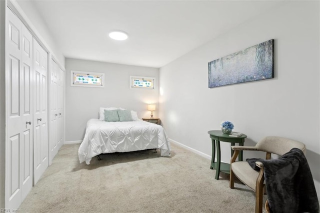 bedroom featuring a closet, carpet flooring, and baseboards