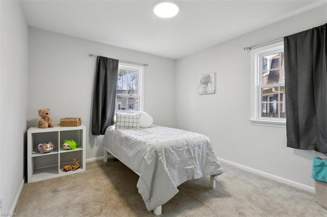 carpeted bedroom featuring baseboards