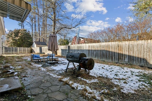 yard layered in snow featuring a fenced backyard