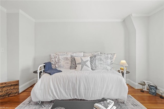 bedroom with hardwood / wood-style floors and crown molding