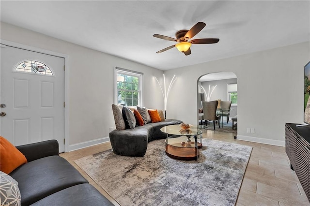 tiled living room featuring ceiling fan