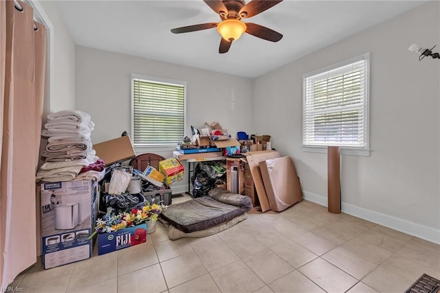 interior space featuring light tile patterned floors and ceiling fan