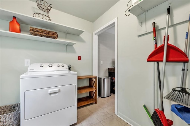 clothes washing area featuring washer / dryer and light tile patterned floors