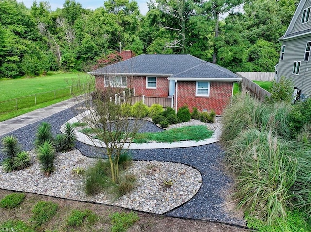 view of front of home featuring a front yard and a wooden deck