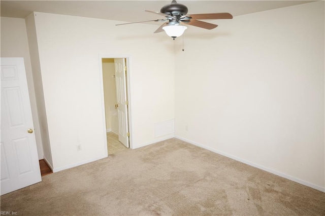 unfurnished room with light colored carpet and ceiling fan