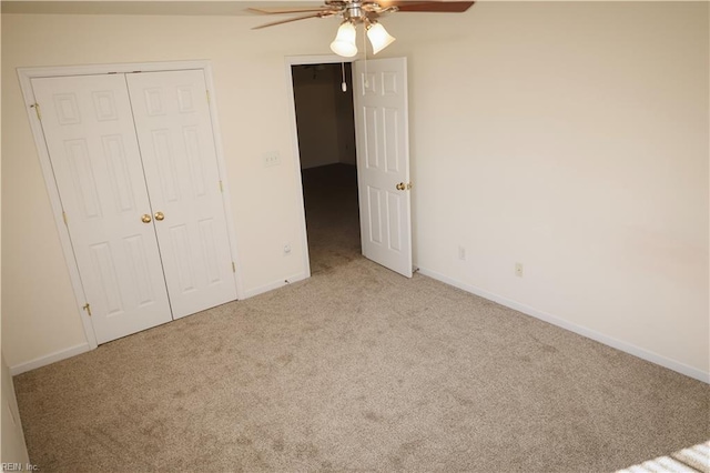 unfurnished bedroom featuring light carpet, ceiling fan, and a closet