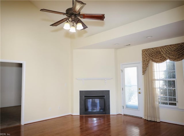 unfurnished living room featuring hardwood / wood-style flooring and ceiling fan