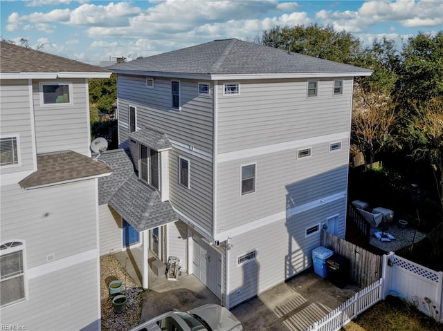 rear view of house featuring a garage